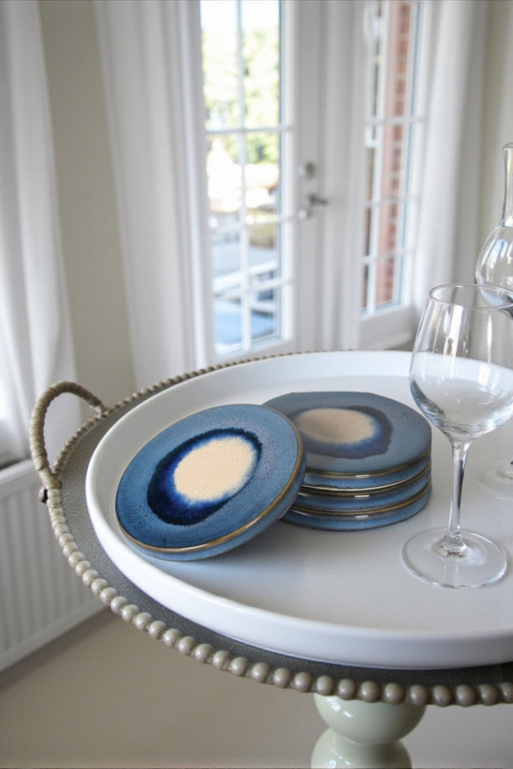 blue coaster on a tray by a window