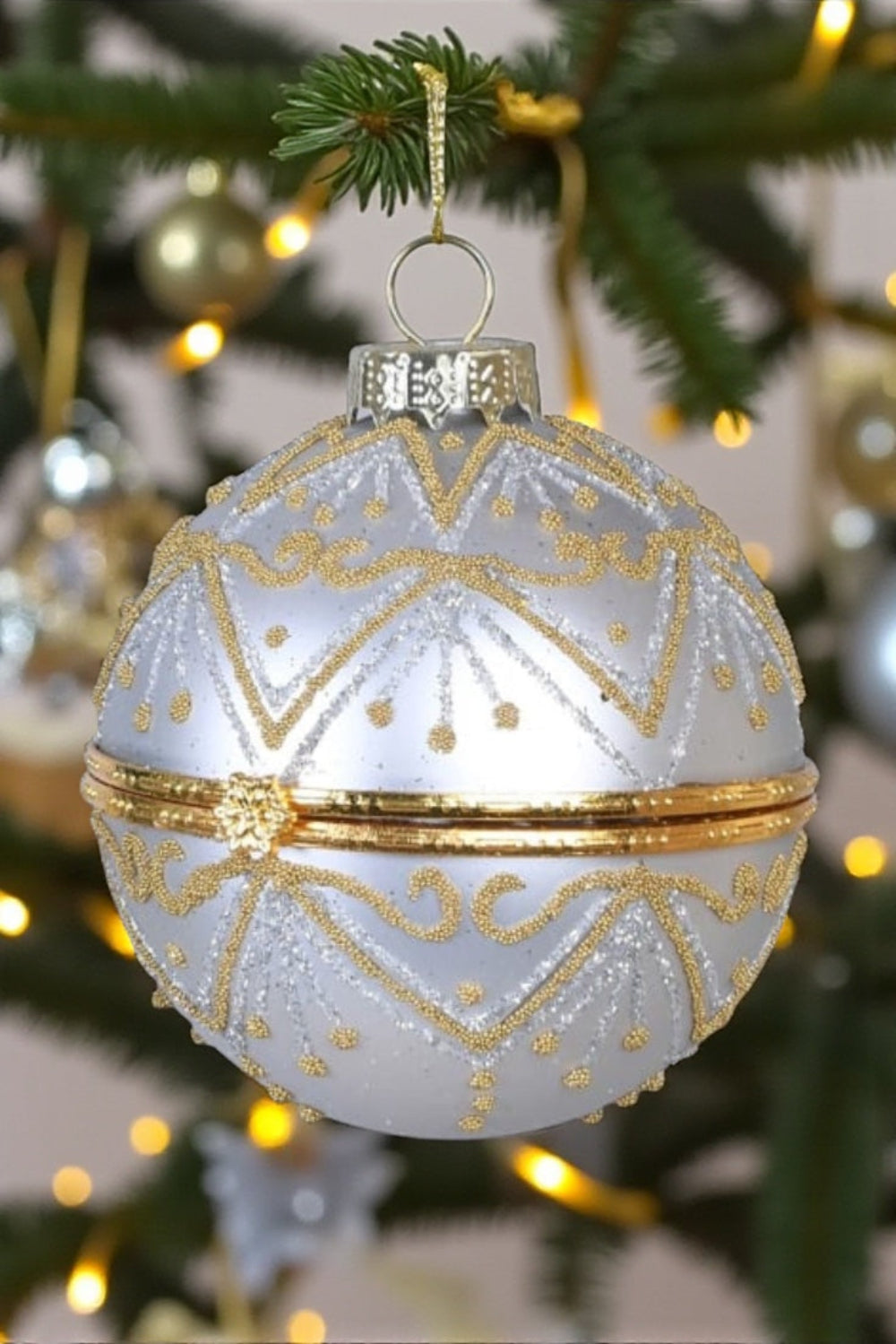 Decorative Christmas ornament with gold patterns on a tree