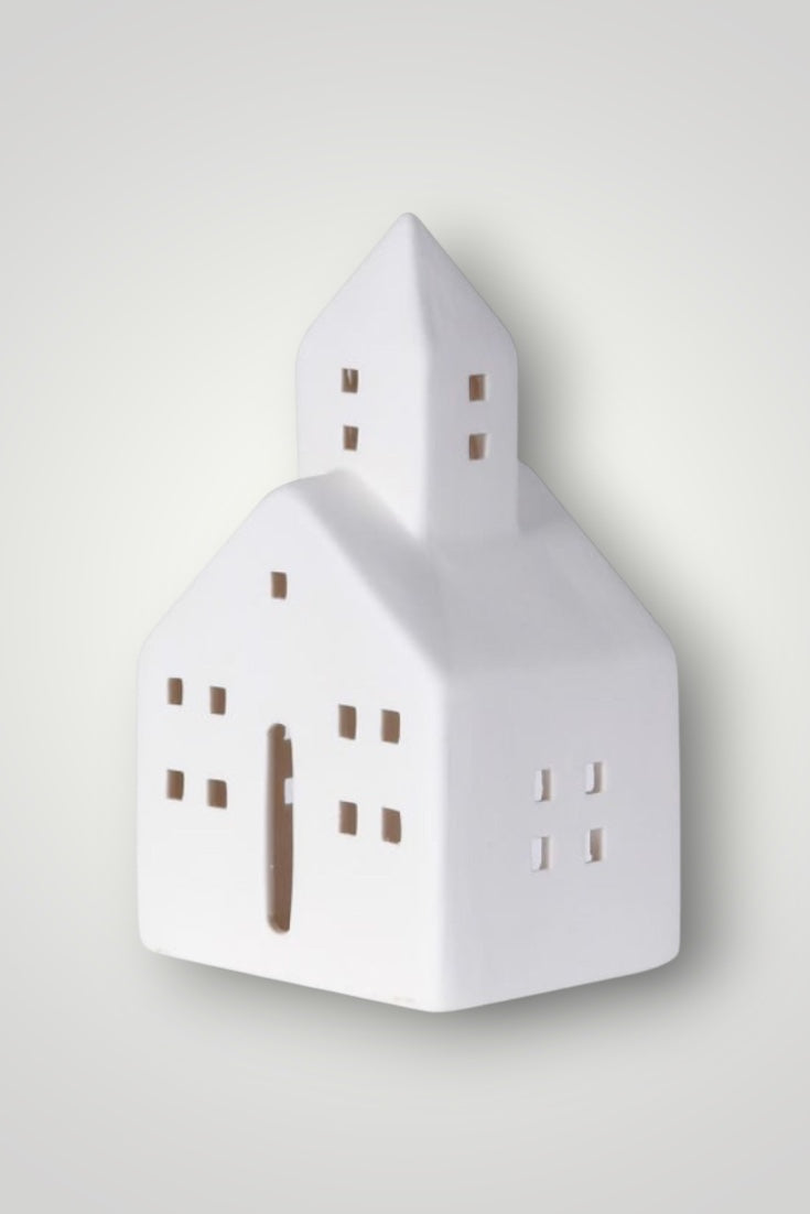 White house-shaped decorative item on a light gray background