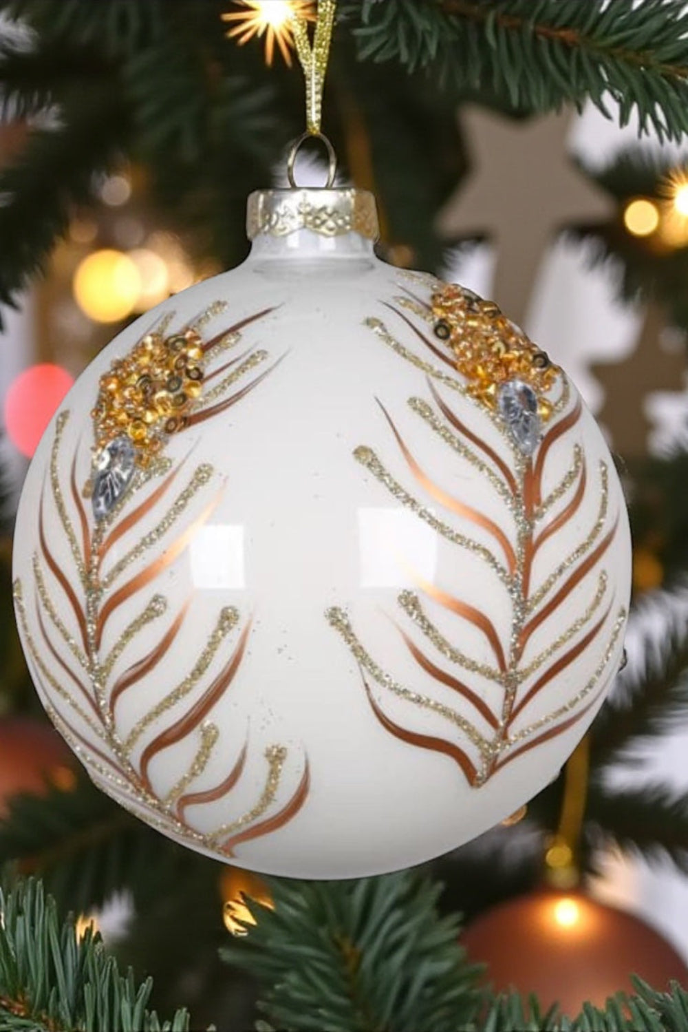 Decorative Christmas ornament with gold and silver patterns on a tree.