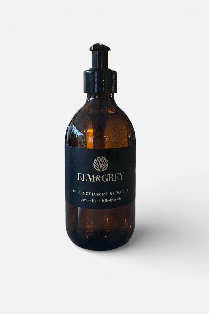 Amber bottle with black cap labeled 'Elm&Grey' on a white background