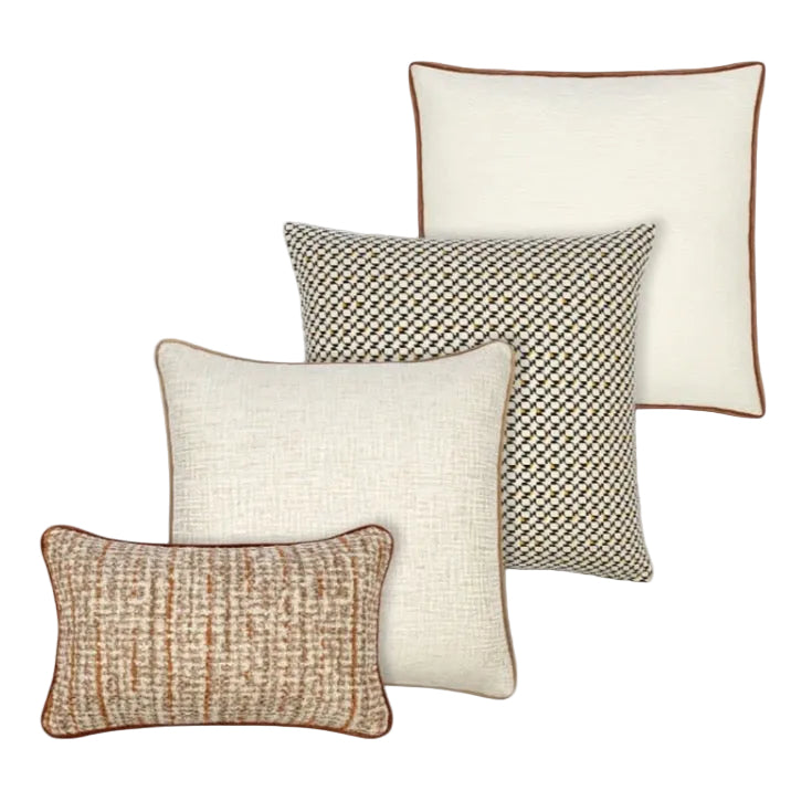 Four decorative pillows in beige, brown, and patterned designs on a white background