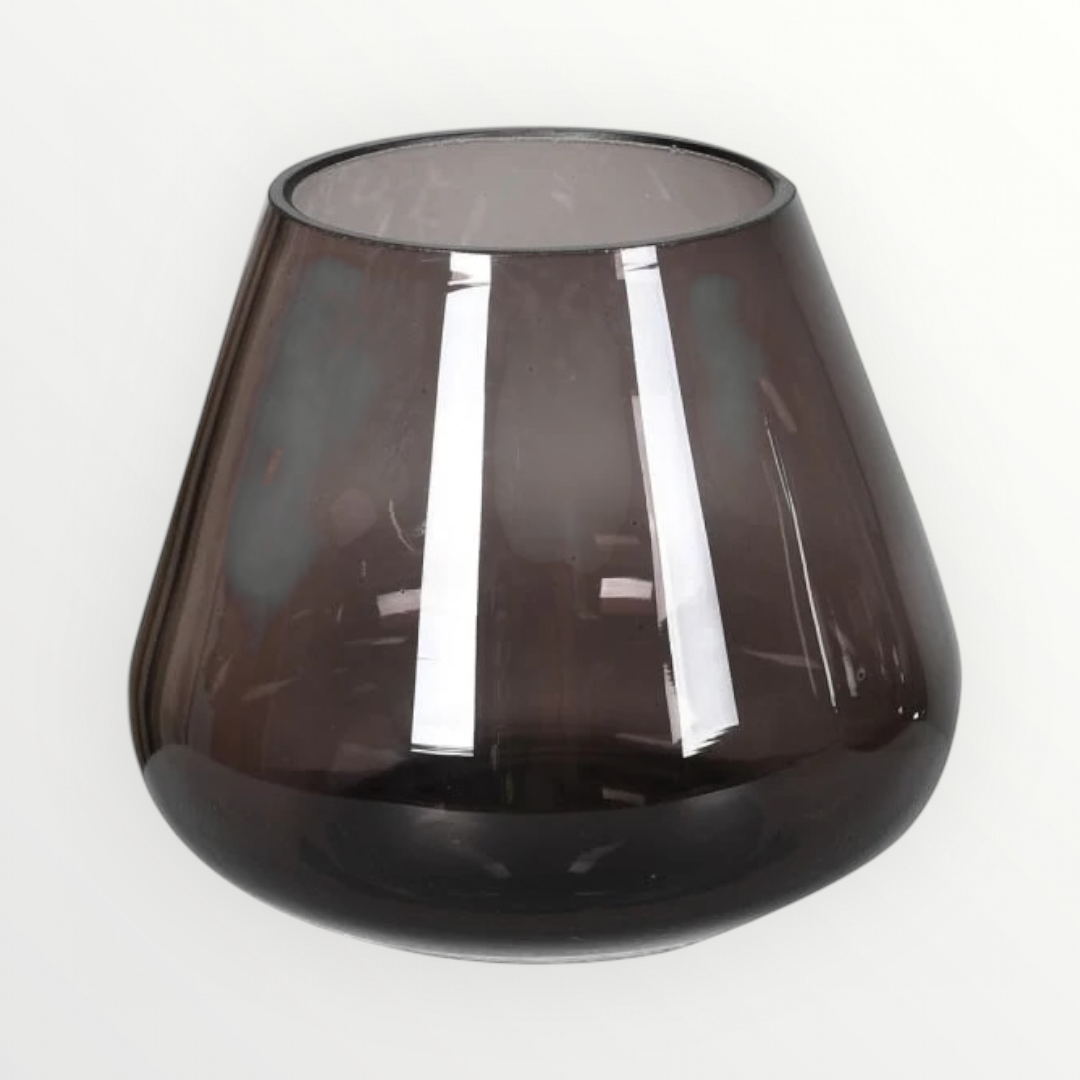 A smoked grey sloping candle holder with a glossy finish, designed to hold a tea light candle.