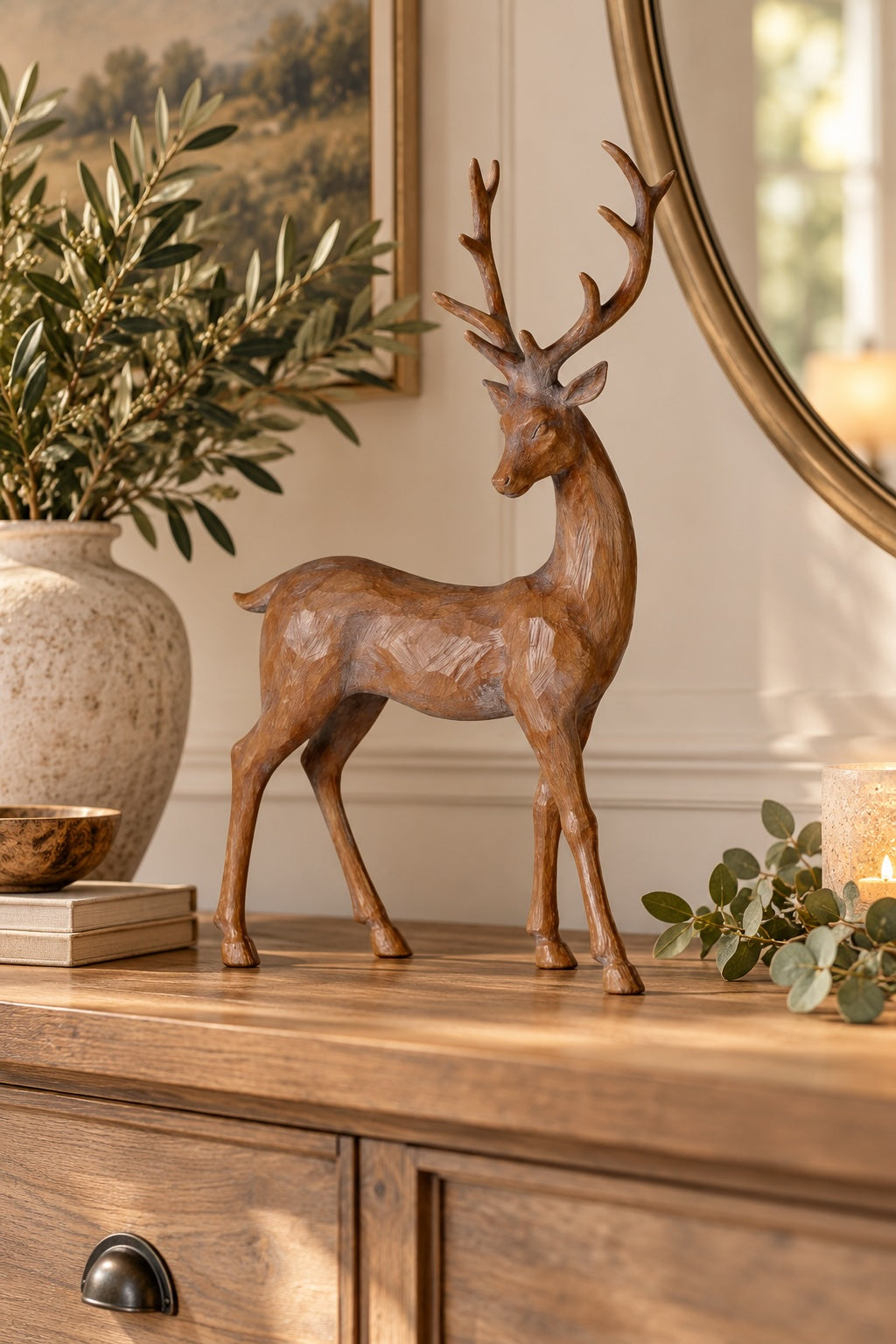 Rustic standing stag styled on a neutral console with greenery and candlelight
