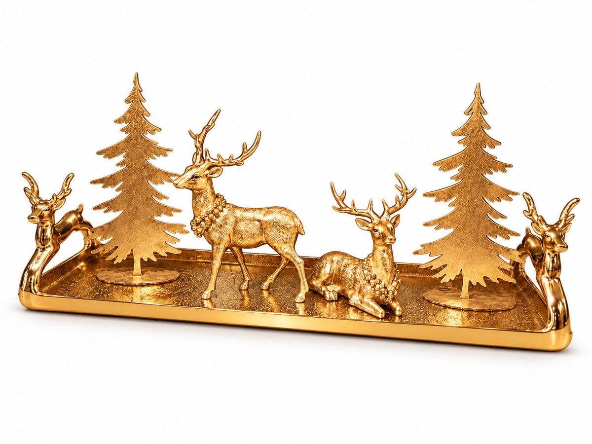 A gold-finished decorative tray featuring three deer figures, two pine trees, and sculpted handles on a plain white background.