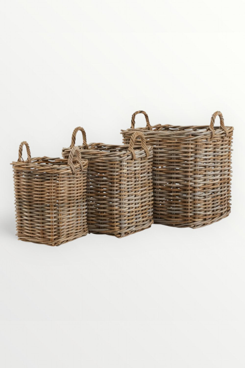 Three wicker baskets of different sizes on a white background