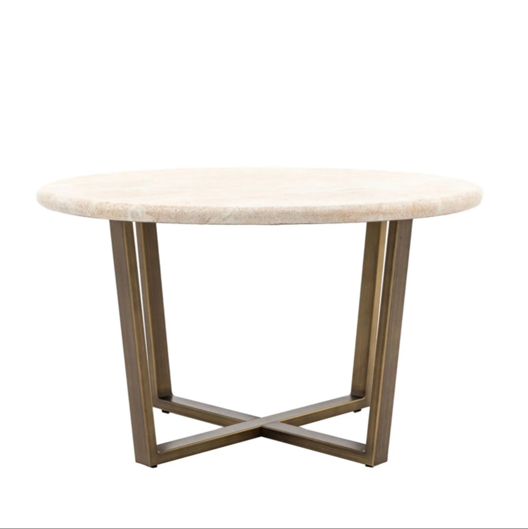Round travertine effect coffee table with brass metal legs on a white background