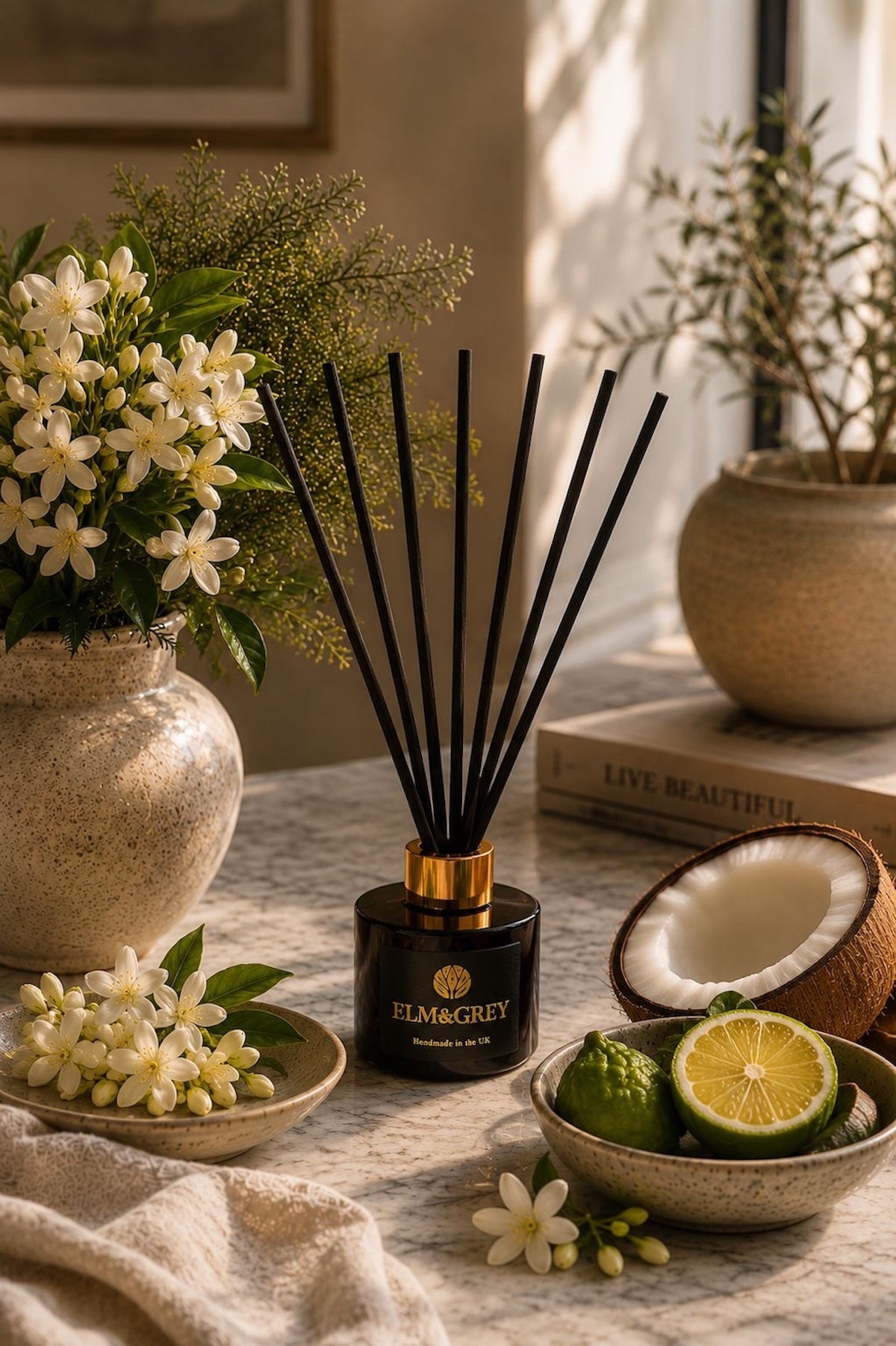 Elm & Grey Bergamot Coconut & Jasmine luxury reed diffuser in a bright sunlit interior with coconut, citrus and jasmine botanicals, inspired by fresh uplifting home fragrance rituals.