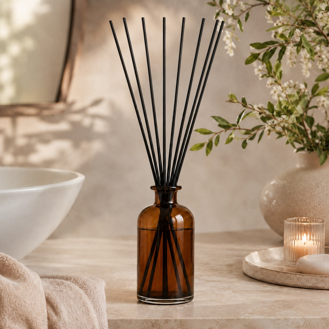 Elm & Grey Bergamot, Jasmine & coconut Statement Reed Diffuser with amber glass vessel and black reeds styled on a console table for large room home fragrance