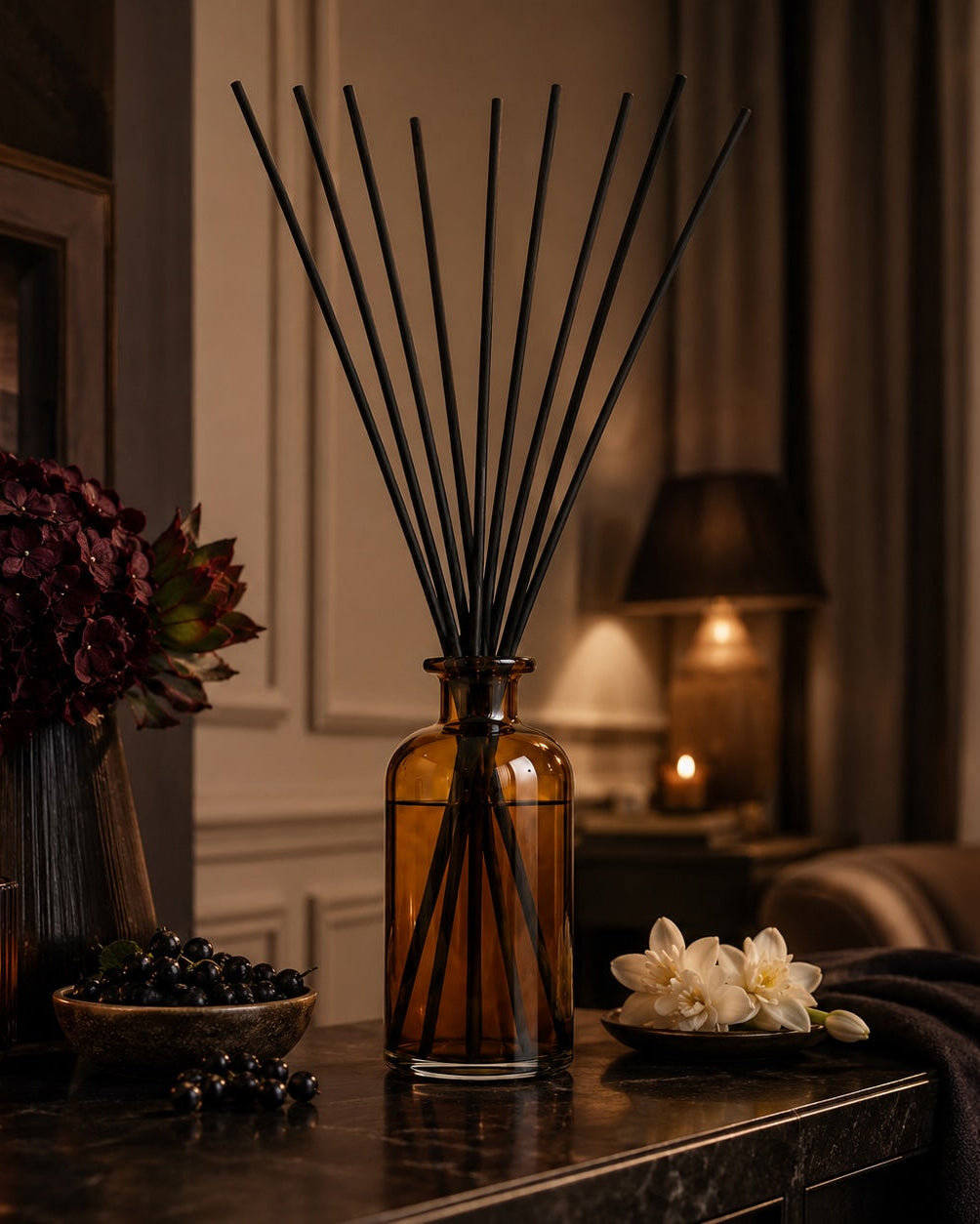 Elm & Grey Blackcurrant & Tuberose Statement Reed Diffuser with amber glass vessel and black reeds styled on a console table for large room home fragrance