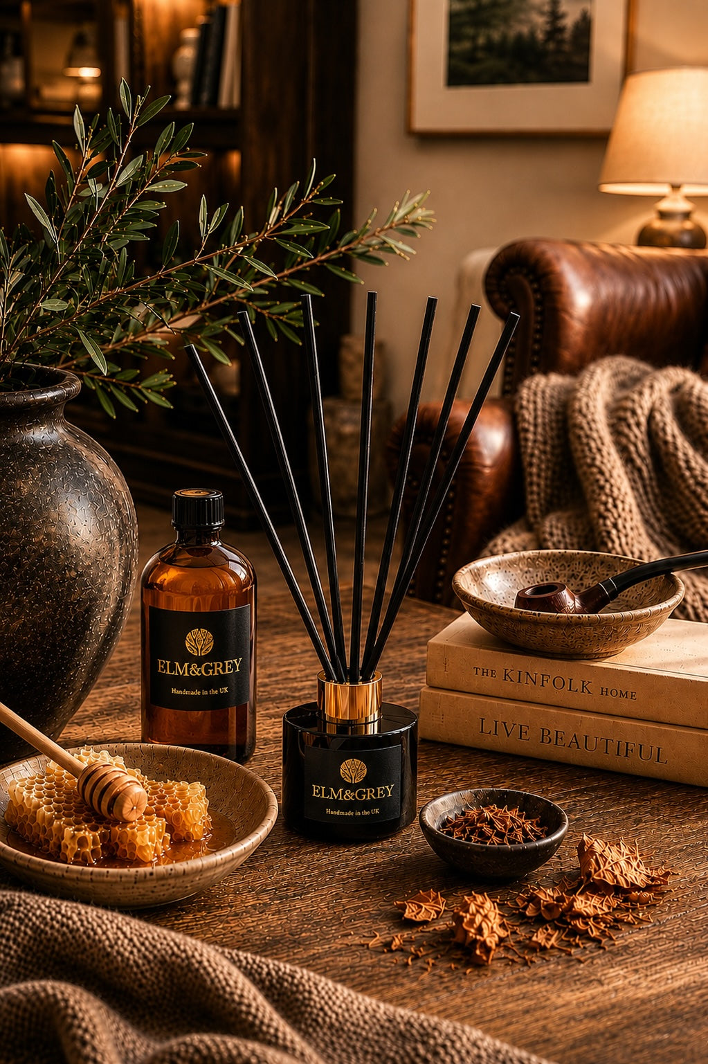 Elm & Grey Dark Honey and Tobacco luxury reed diffuser and diffuser refill bottle on a coffee table in a luxury living room with books and botanicals