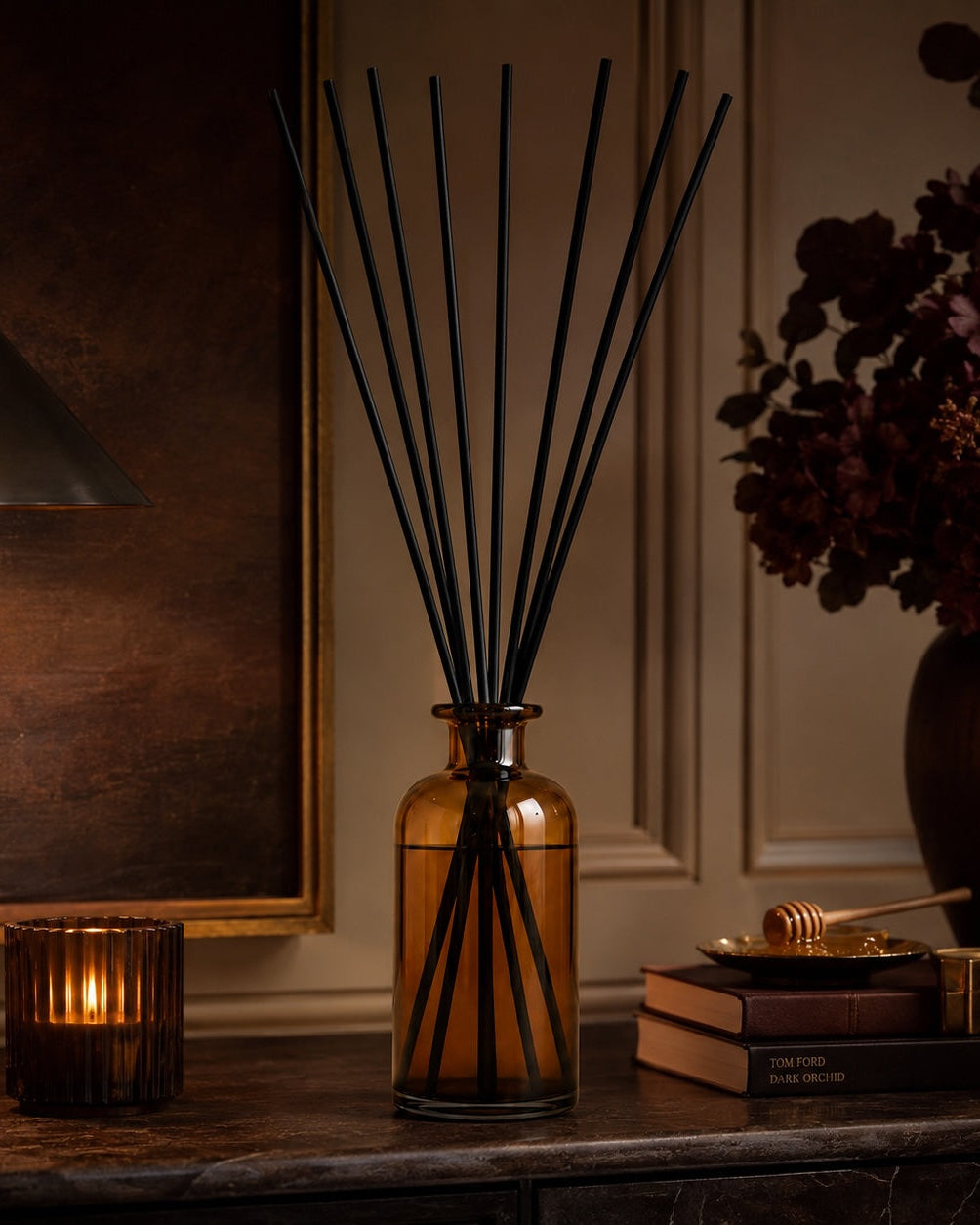 Elm & Grey Dark Honey & Tobacco Statement Reed Diffuser with amber glass vessel and black reeds styled on a console table for large room home fragrance