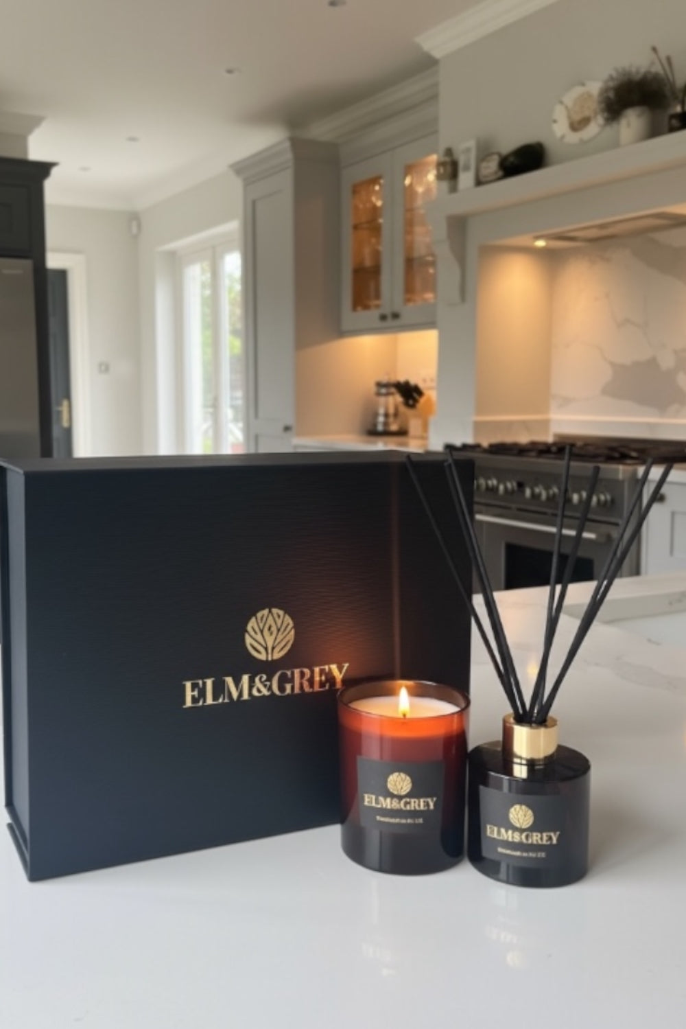 ELM&GREY candle and diffuser set on a kitchen counter with gift box in the background.