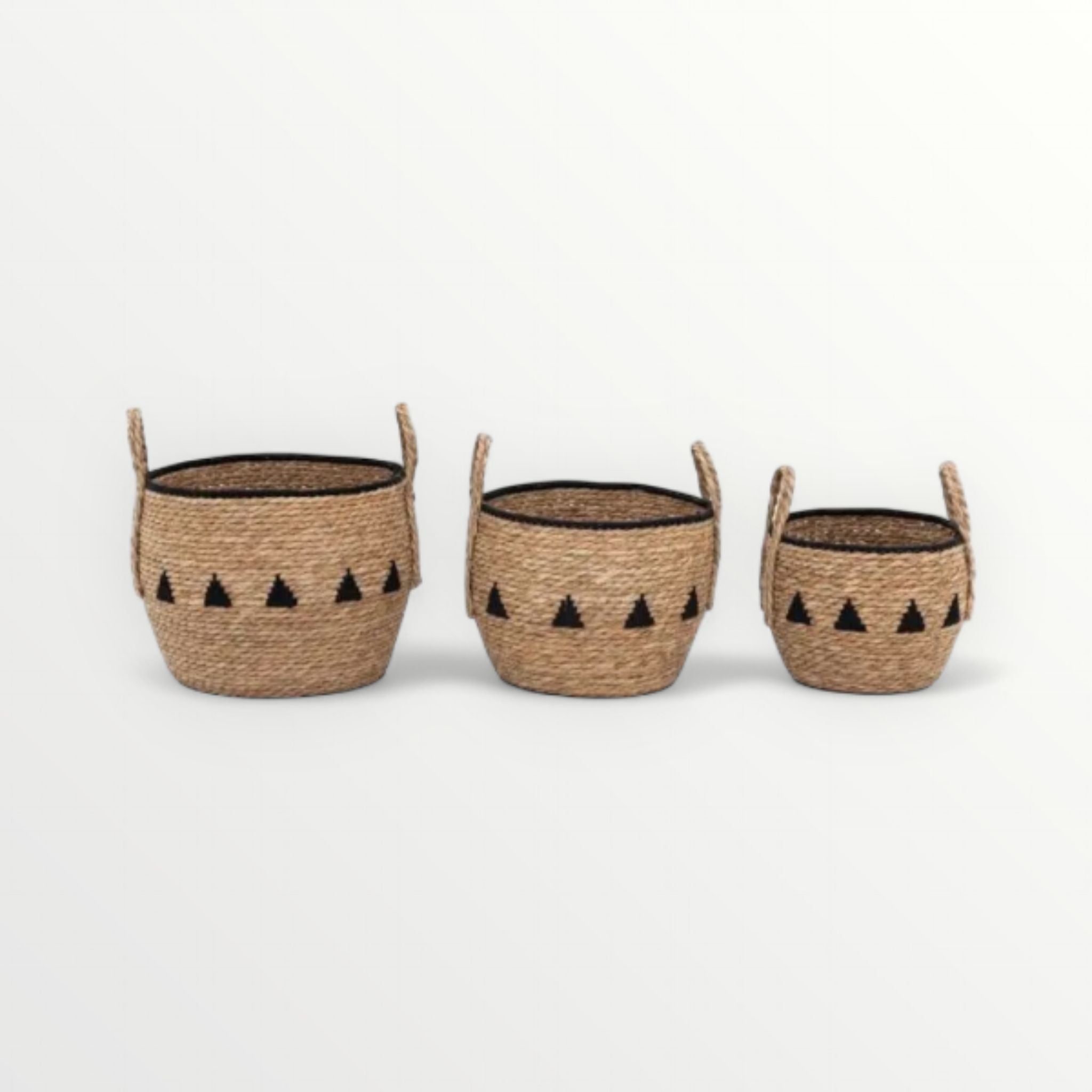 Three woven baskets with black triangle patterns on a white background