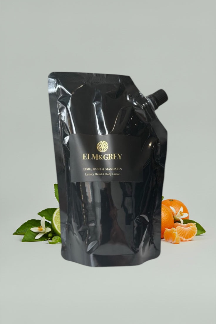 Black pouch with Elm & Grey branding on a light grey background with orange slices and leaves.