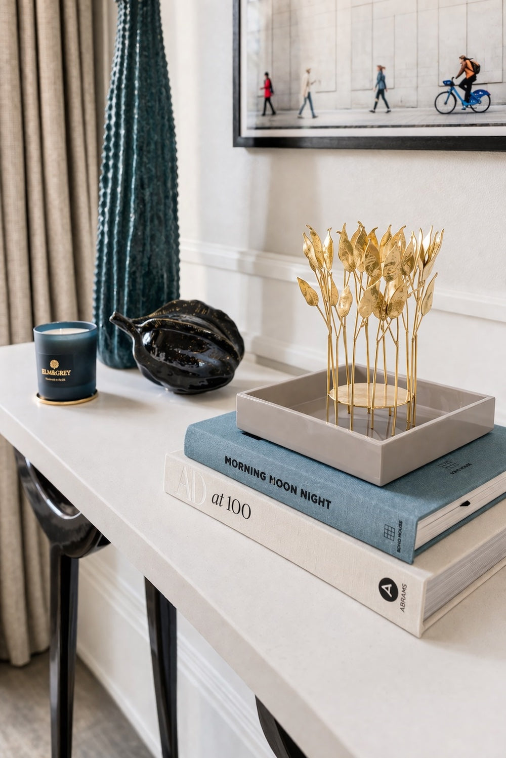 Fawn high gloss lacquer square tray with gold botanical leaf sculpture on a white console table with Elm & Grey candle, tall teal vase and black ceramic leaf dish — Elm & Grey
