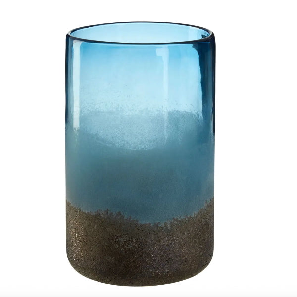 Tall glass with blue top and brown bottom on a white background