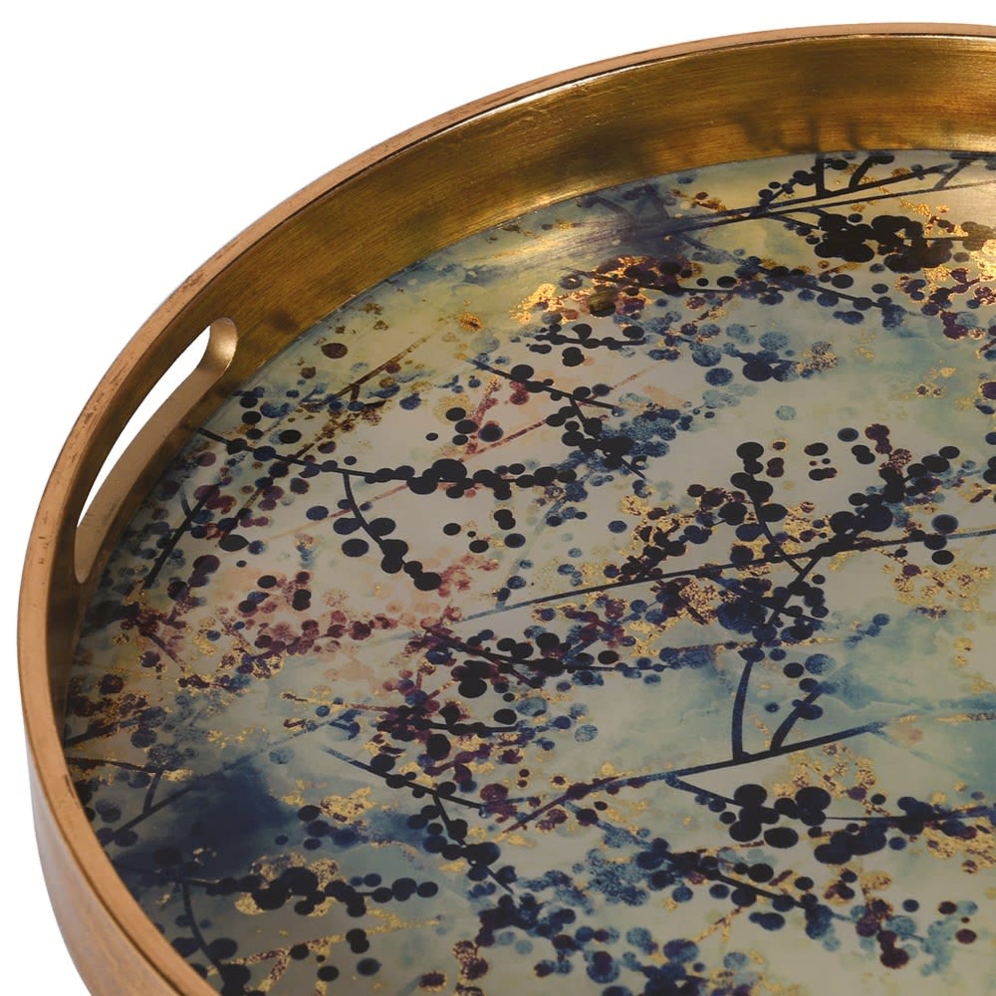 Round decorative tray with artistic design and gold rim on a white background
