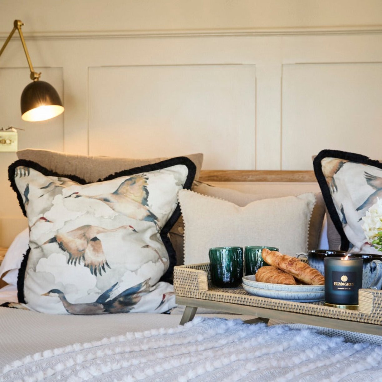 Bed with rabbit throw and crane cushions