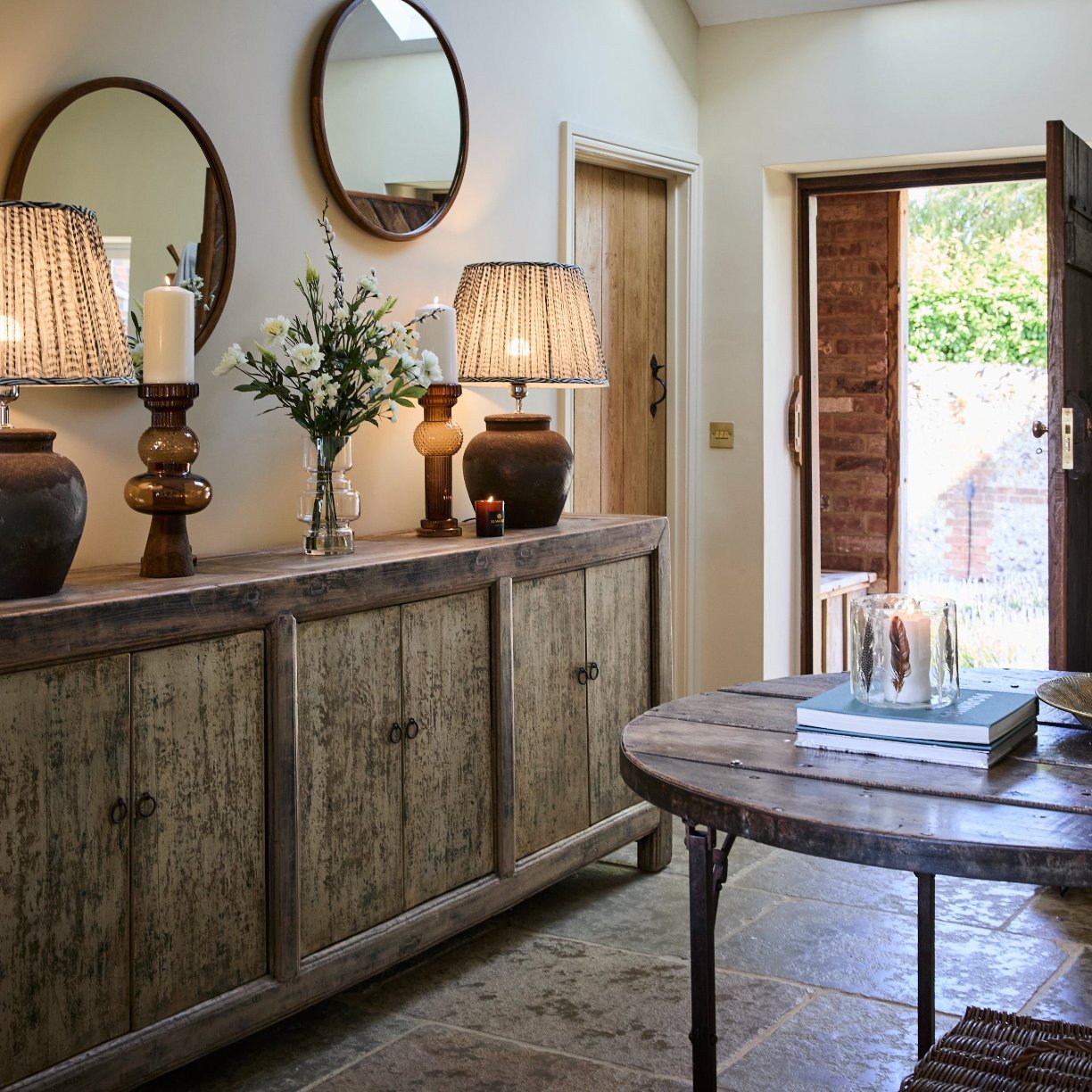 Entryway with matching amber pilar candles and lamps with feather candle holder and faux flowers