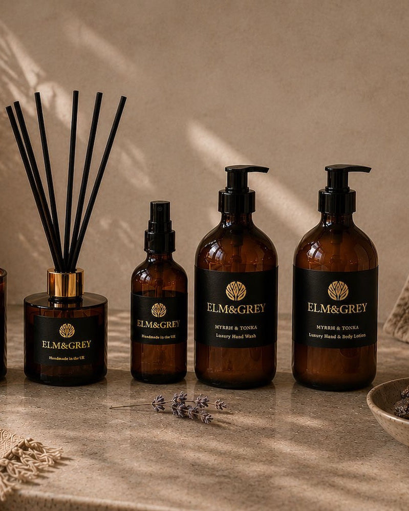 Elm & Grey Myrrh and Tonka collection — candle, reed diffuser, room spray, hand wash and body lotion styled with dried lavender and tonka beans