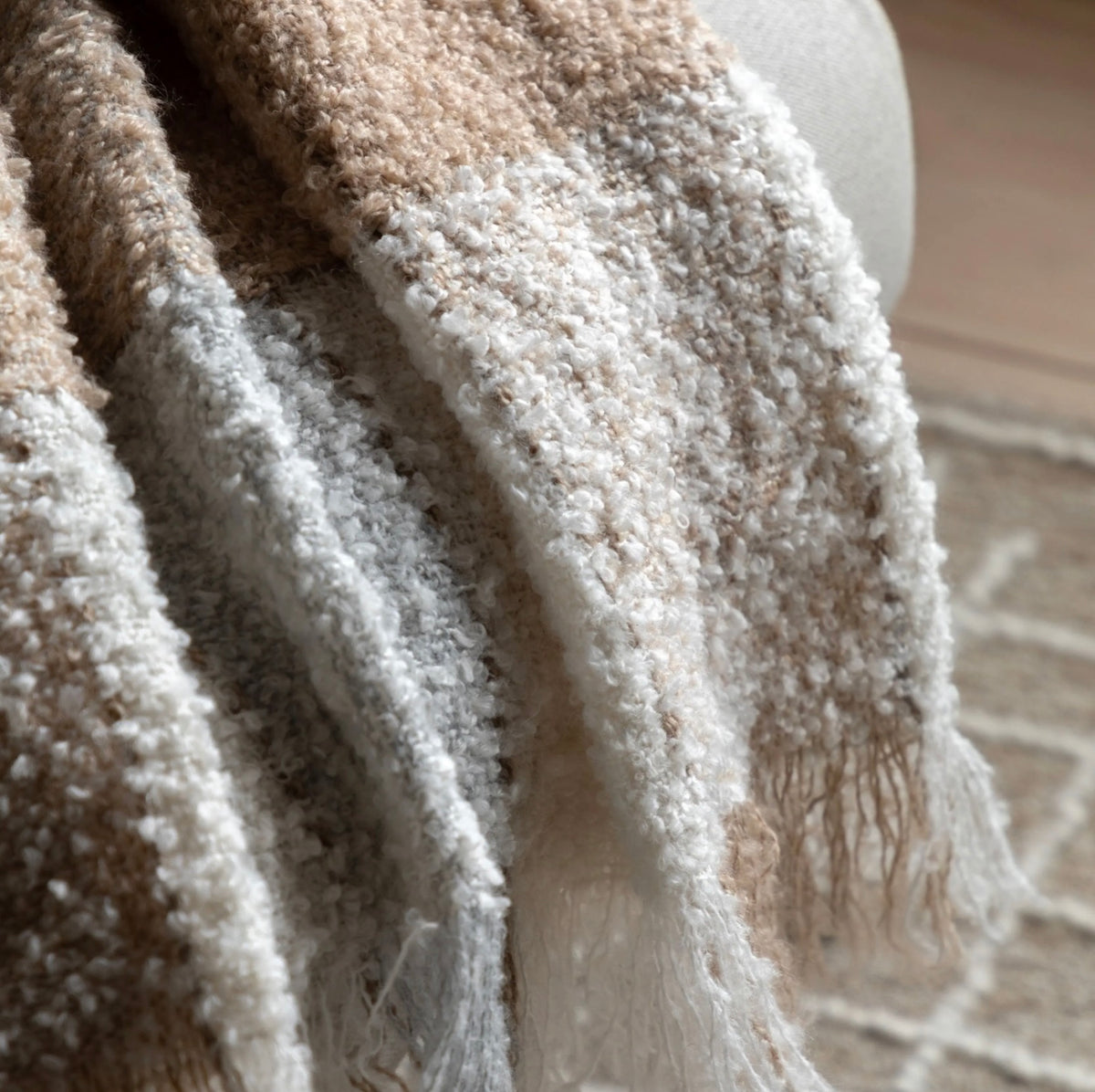 Close-up of textured fabric with a neutral color palette.