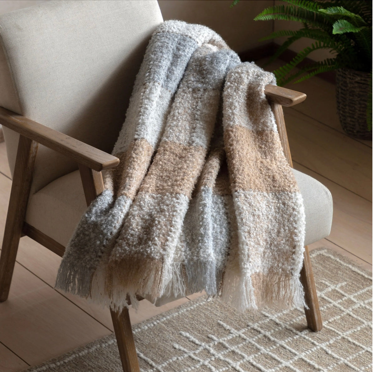 Textured blanket draped over a chair in a home setting