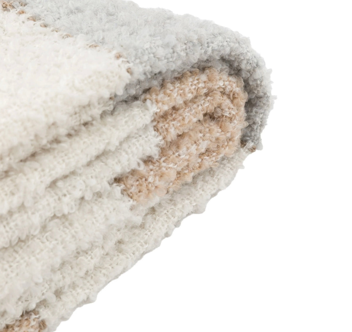 Close-up of a textured fabric with a neutral color palette on a white background