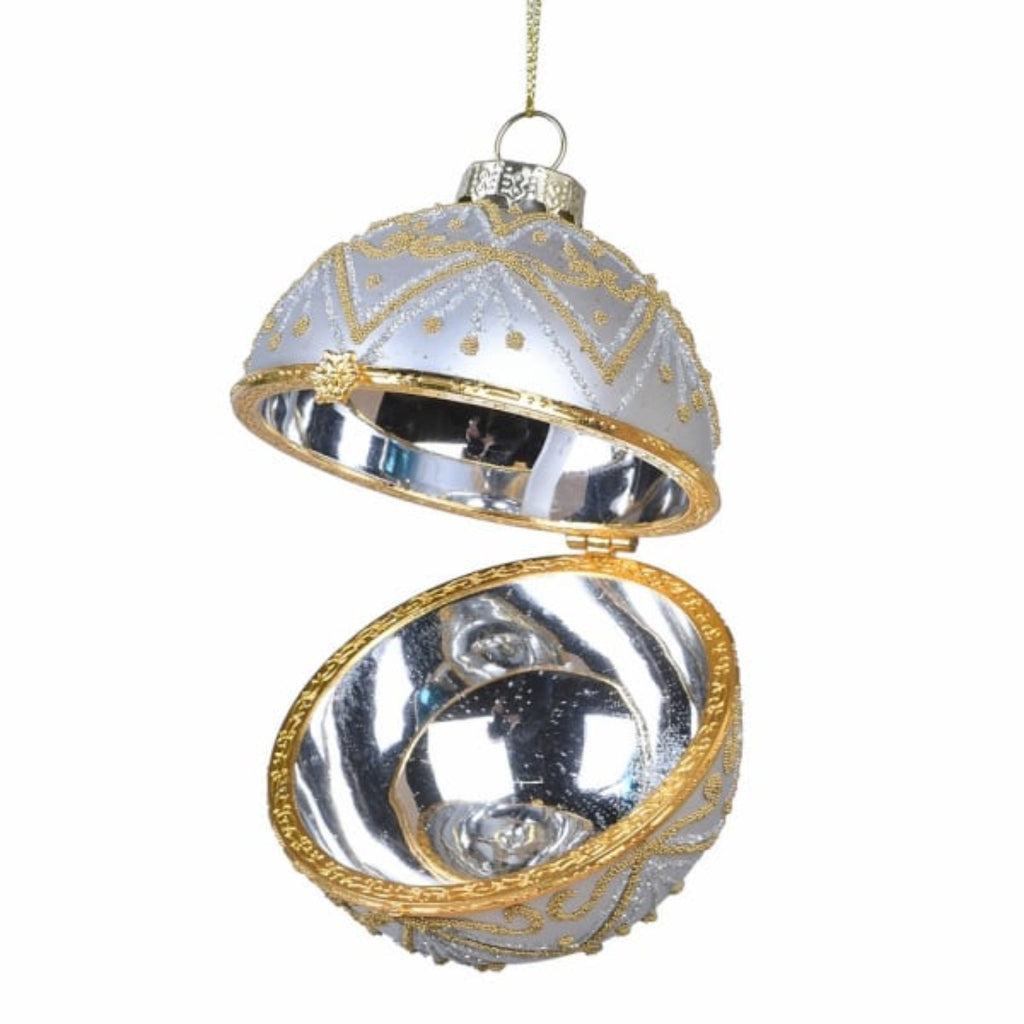 Decorative openable keepsake glass ornament with gold and silver design on a white background