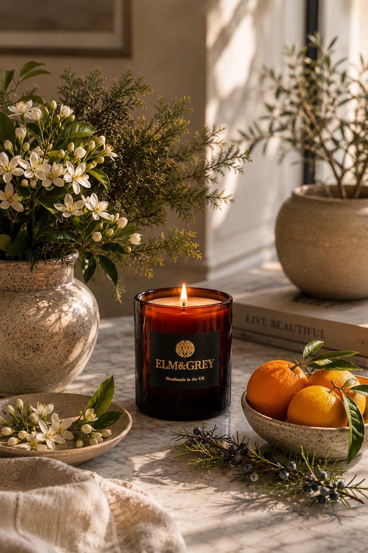Elm & Grey Orange Blossom & Juniper luxury home fragrance featuring a hand-poured scented candle styled with fresh citrus, orange blossom and aromatic juniper.