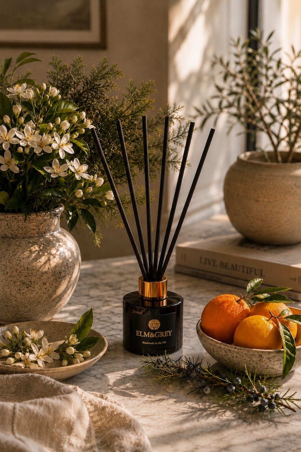 Elm & Grey Orange Blossom & Juniper luxury home fragrance featuring a hand-made reed diffuser styled with fresh citrus, orange blossom and aromatic juniper.