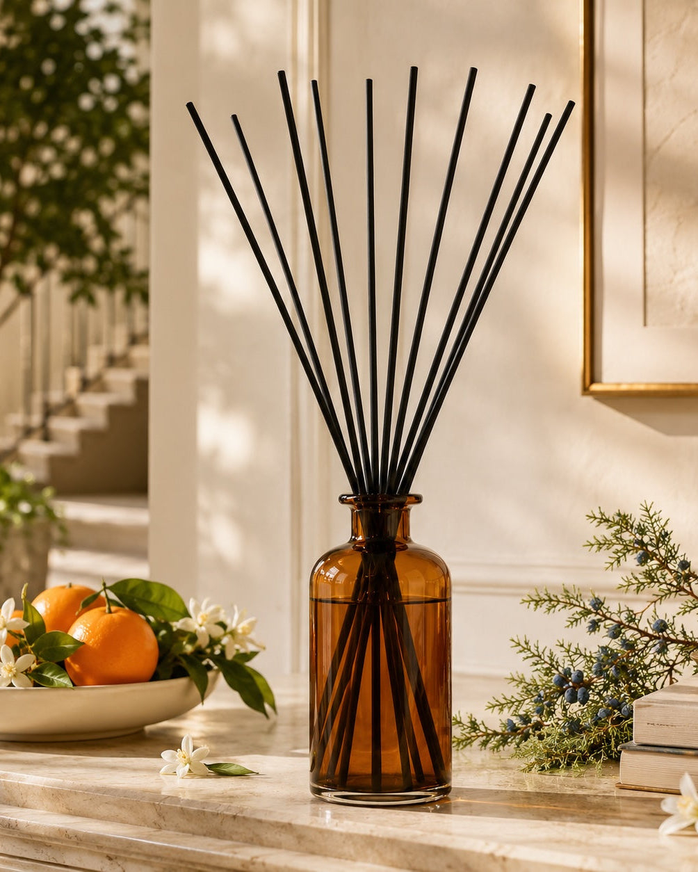 Elm & Grey Orange Blossom & Juniper Statement Reed Diffuser with amber glass vessel and black reeds styled on a console table for large room home fragrance