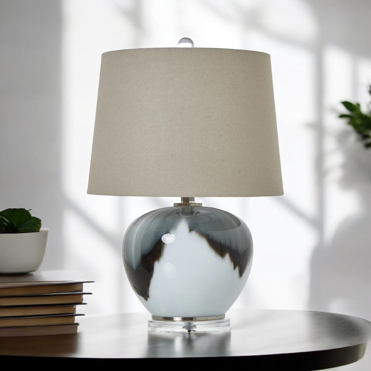 Table lamp with a gray and white marbled base and beige lampshade on a white background, Elm & Grey.