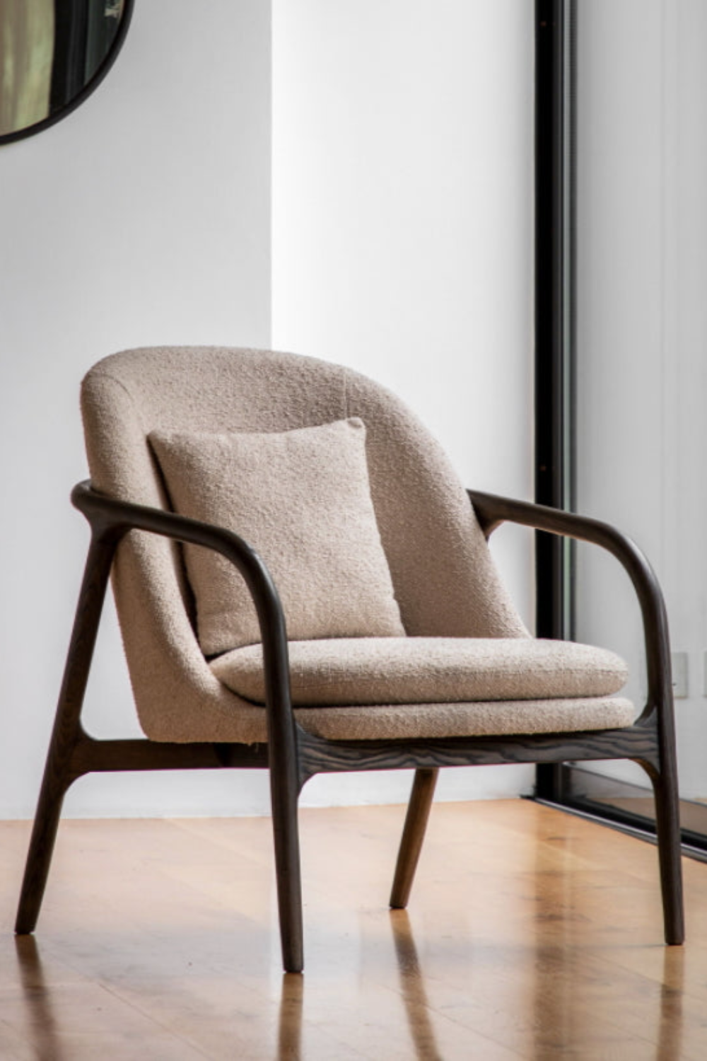 Beige armchair with wooden frame in a minimalistic room