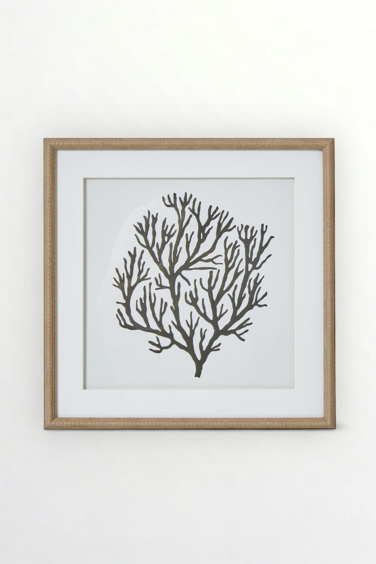 Framed artwork of a black coral design on a white wall, Elm & Grey.
