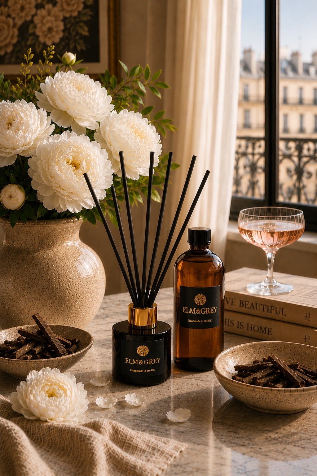 Luxury Velvet Peony & Oud reed diffuser with refill bottle by Elm & Grey, styled with white peonies and warm neutral décor in an elegant interior setting.