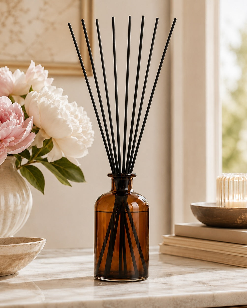 Elm & Grey Velvet Peony & Oud Statement Reed Diffuser with amber glass vessel and black reeds styled on a console table for large room home fragrance
