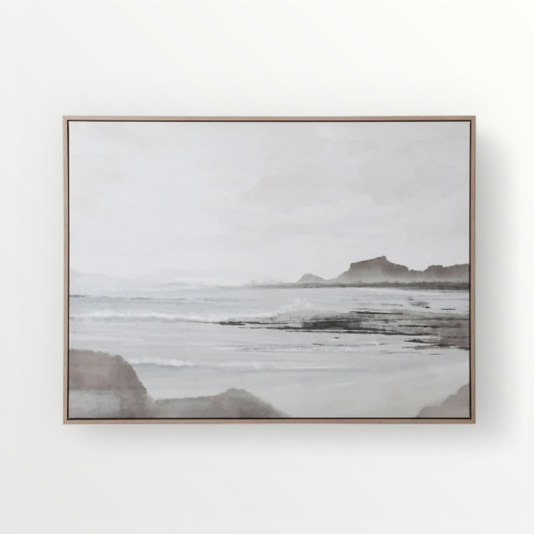 A framed canvas artwork depicting a serene coastal scene with soft, muted tones and delicate brushstrokes, evoking a tranquil atmosphere.