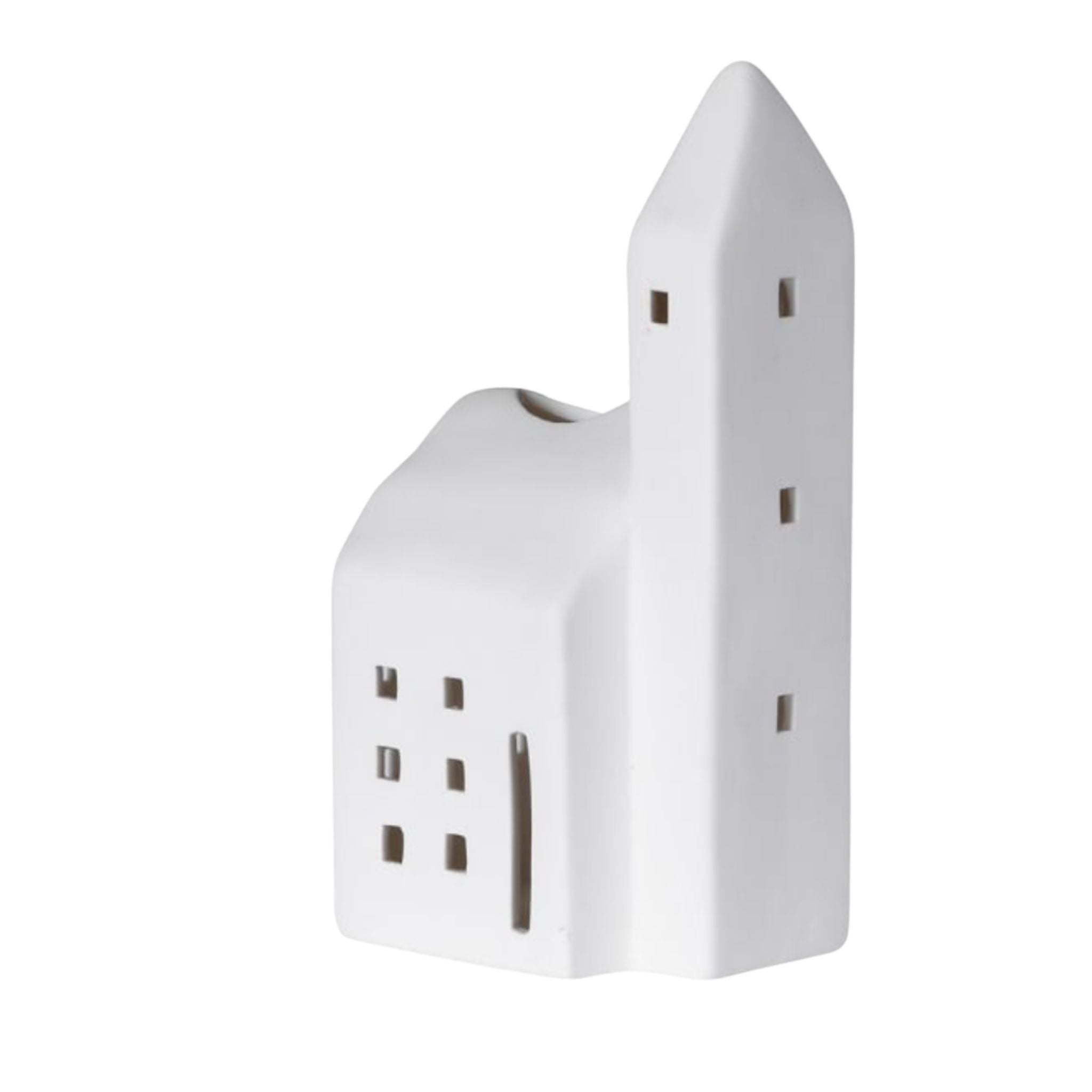 A ceramic church tealight holder casting chapel-like windows of light