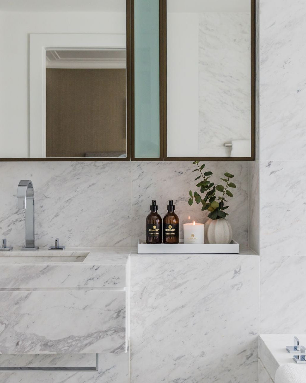 White high gloss lacquer rectangular styling tray in a luxury white marble bathroom with Elm & Grey hand wash, body lotion and candle with eucalyptus