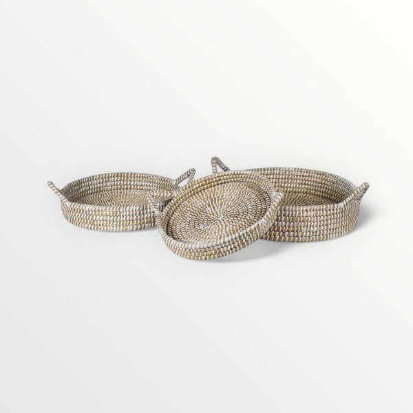 Set of three woven trays on a white background