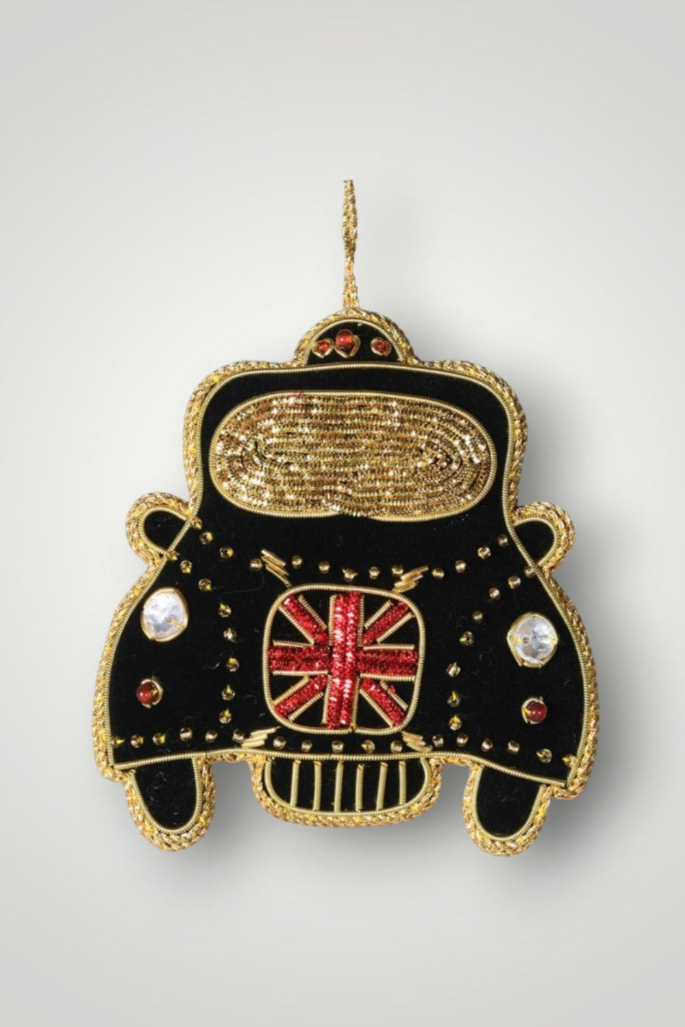 Decorative ornament shaped like a black car with gold accents and a Union Jack flag on a white background.