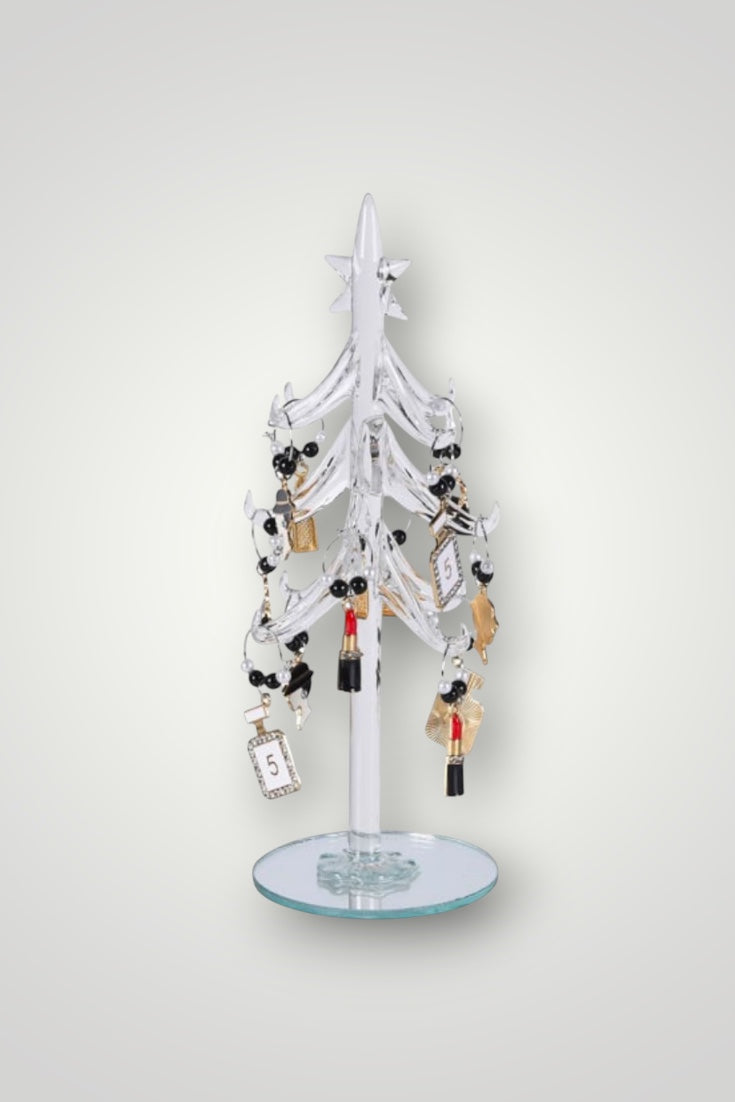 Decorative table top glass tree with hanging items on a white background