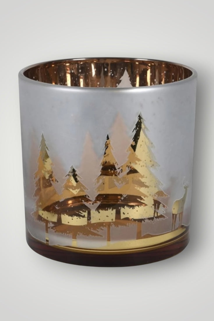 Decorative candle holder with a gold landscape design on a white background