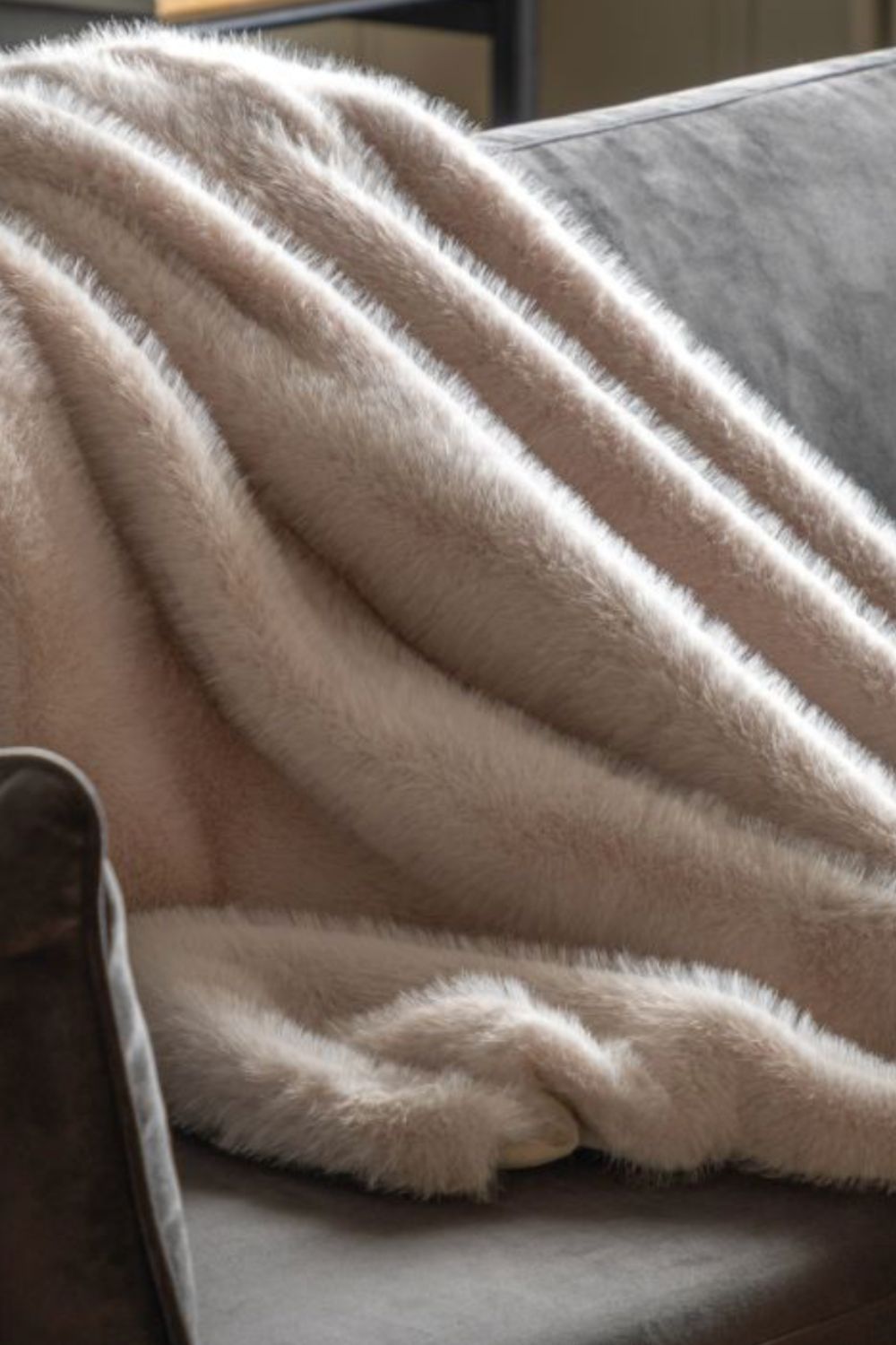 Beige oatmeal blanket draped over a surface with a neutral background