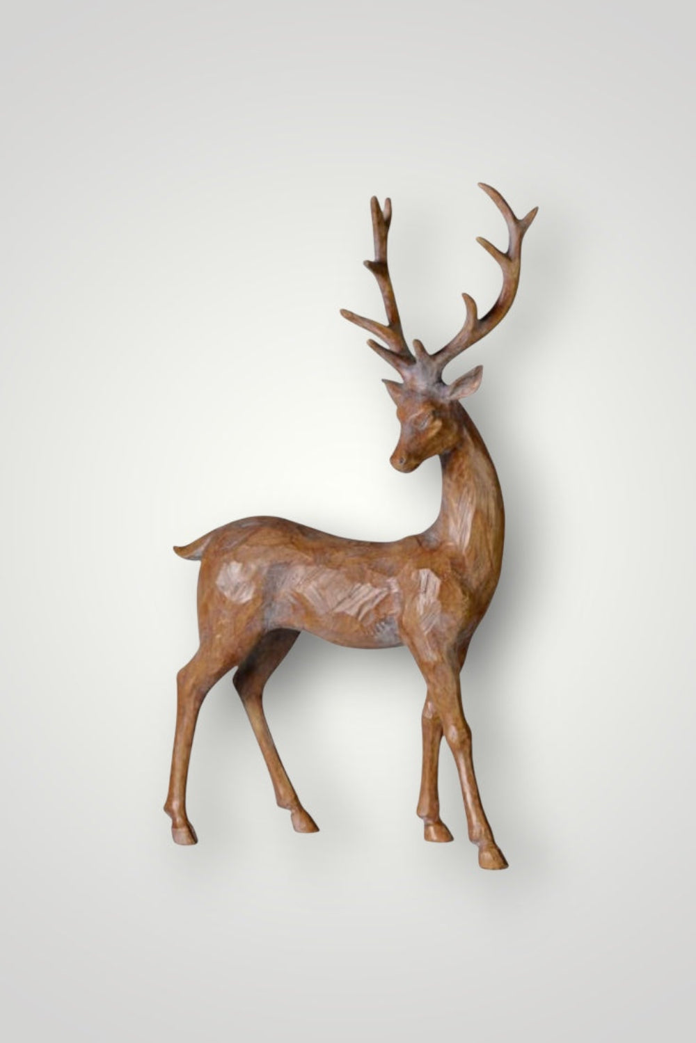 wooden deer sculpture on a white background