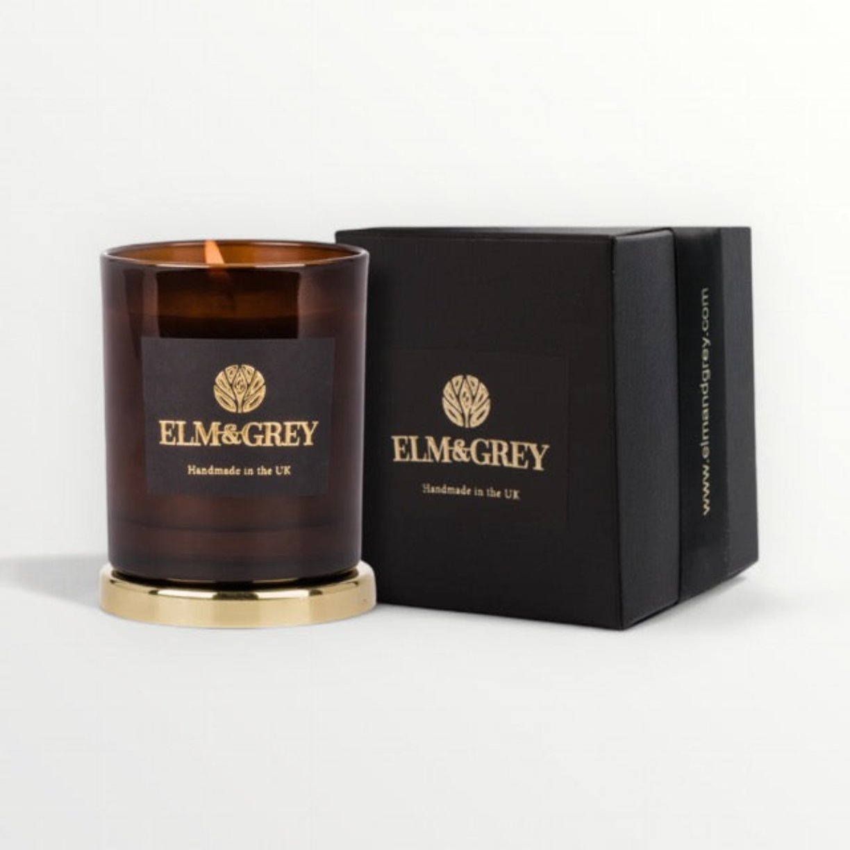 Amber candle 165g next to a black gift box