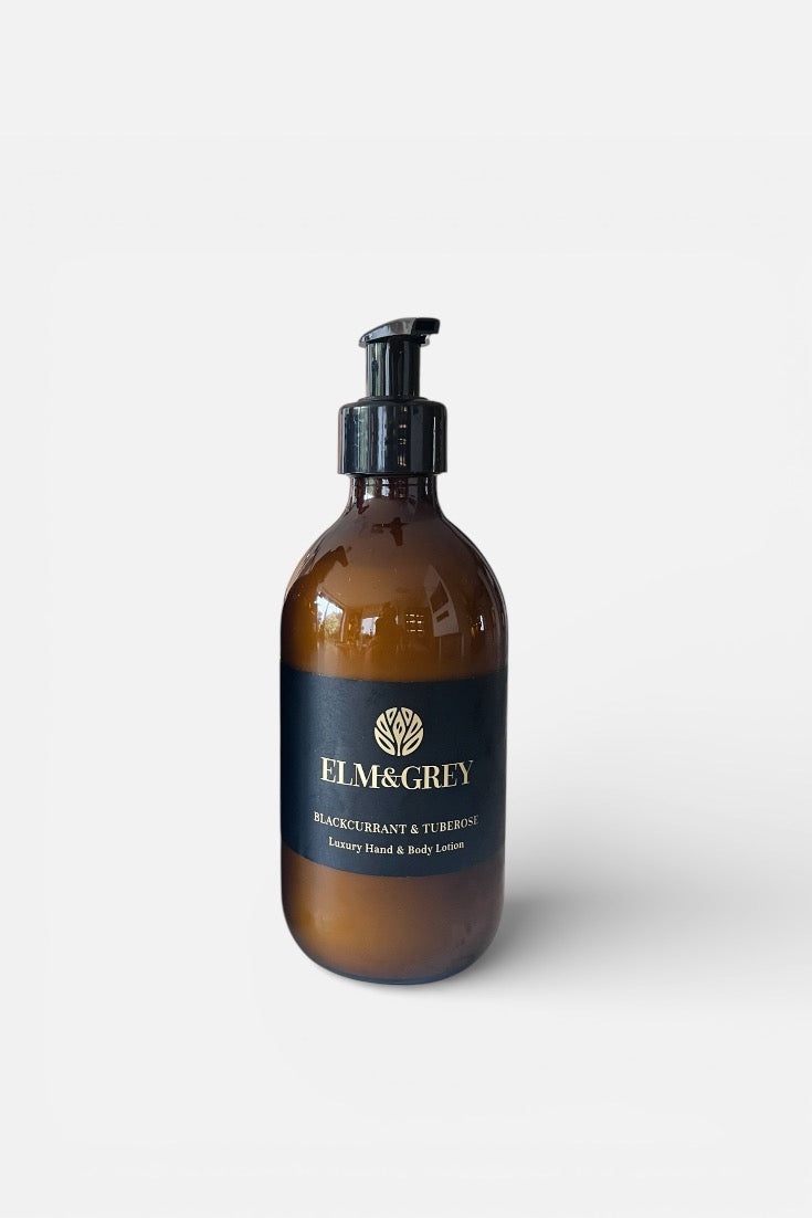 Amber bottle with pump and 'ELM&GREY' label on a white background