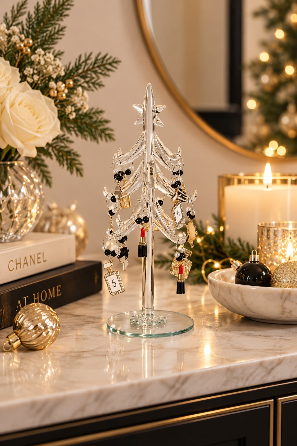 Glass tabletop Christmas tree with miniature baubles styled in an elegant festive setting