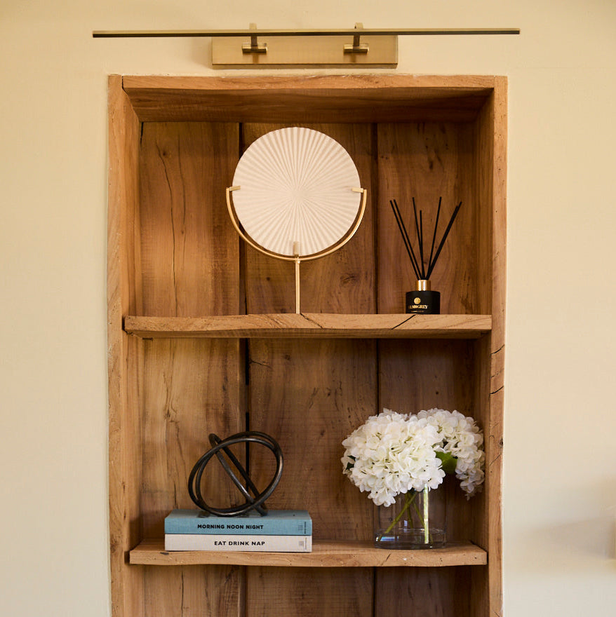 rustic wodden shelving with metal ring on a pile of books